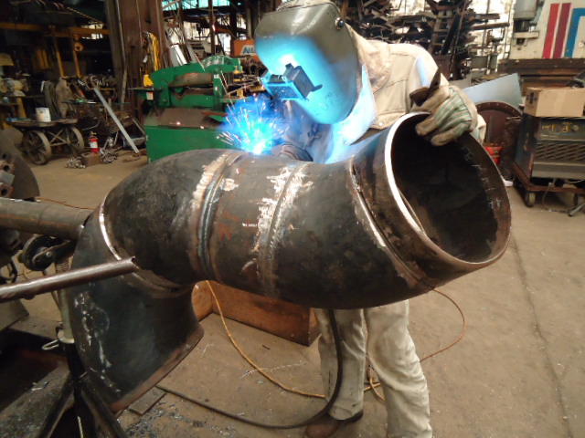 employee welding loading arm